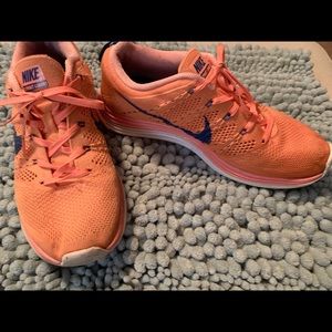 Coral flyknit Nike shoes